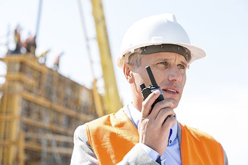 Construction worker using two-way radio