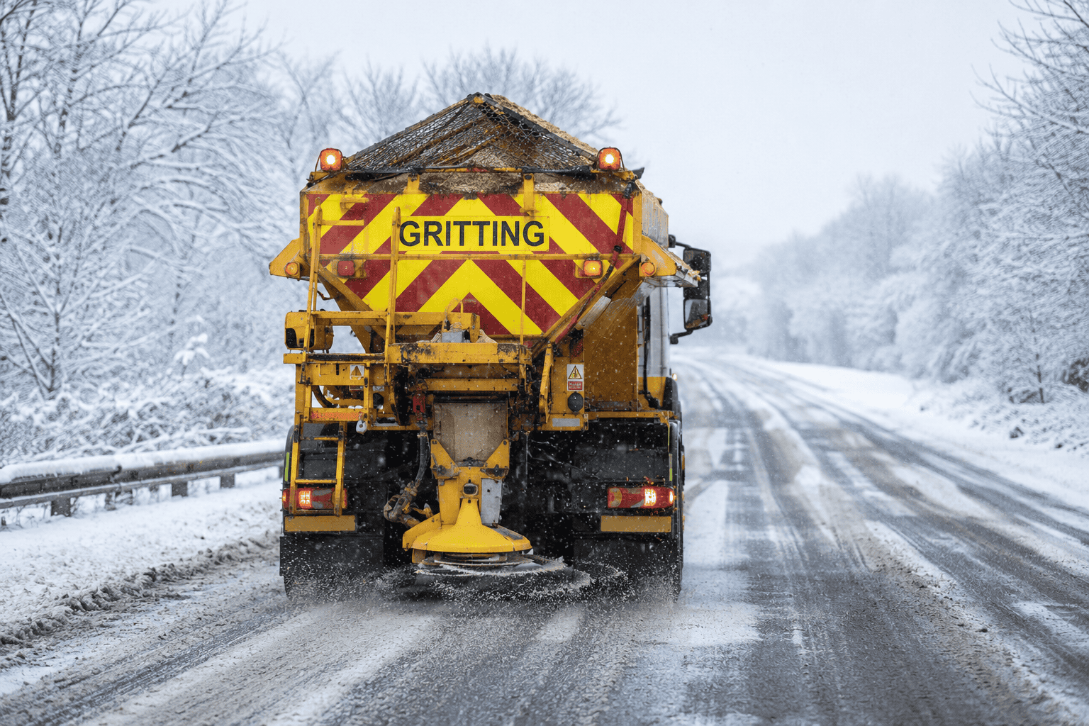 Winter gritting truck in snowy landscape Winter gritting truck in snowy landscape