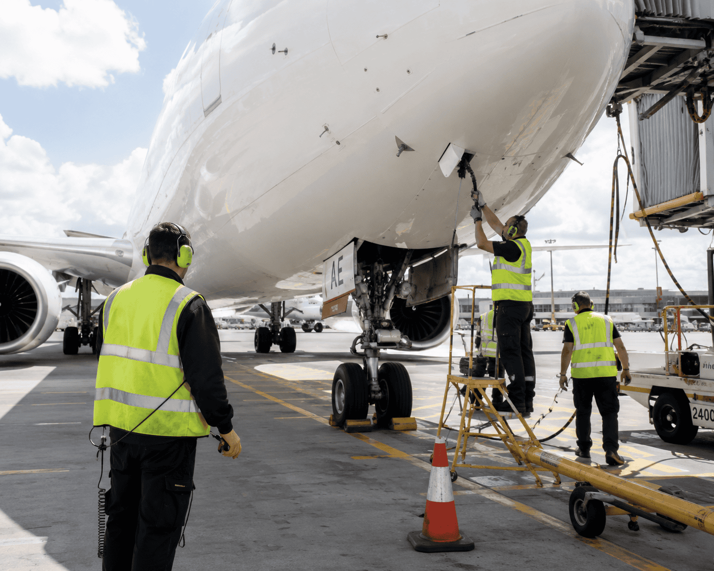 ground crew working on a plane ground crew working on a plane