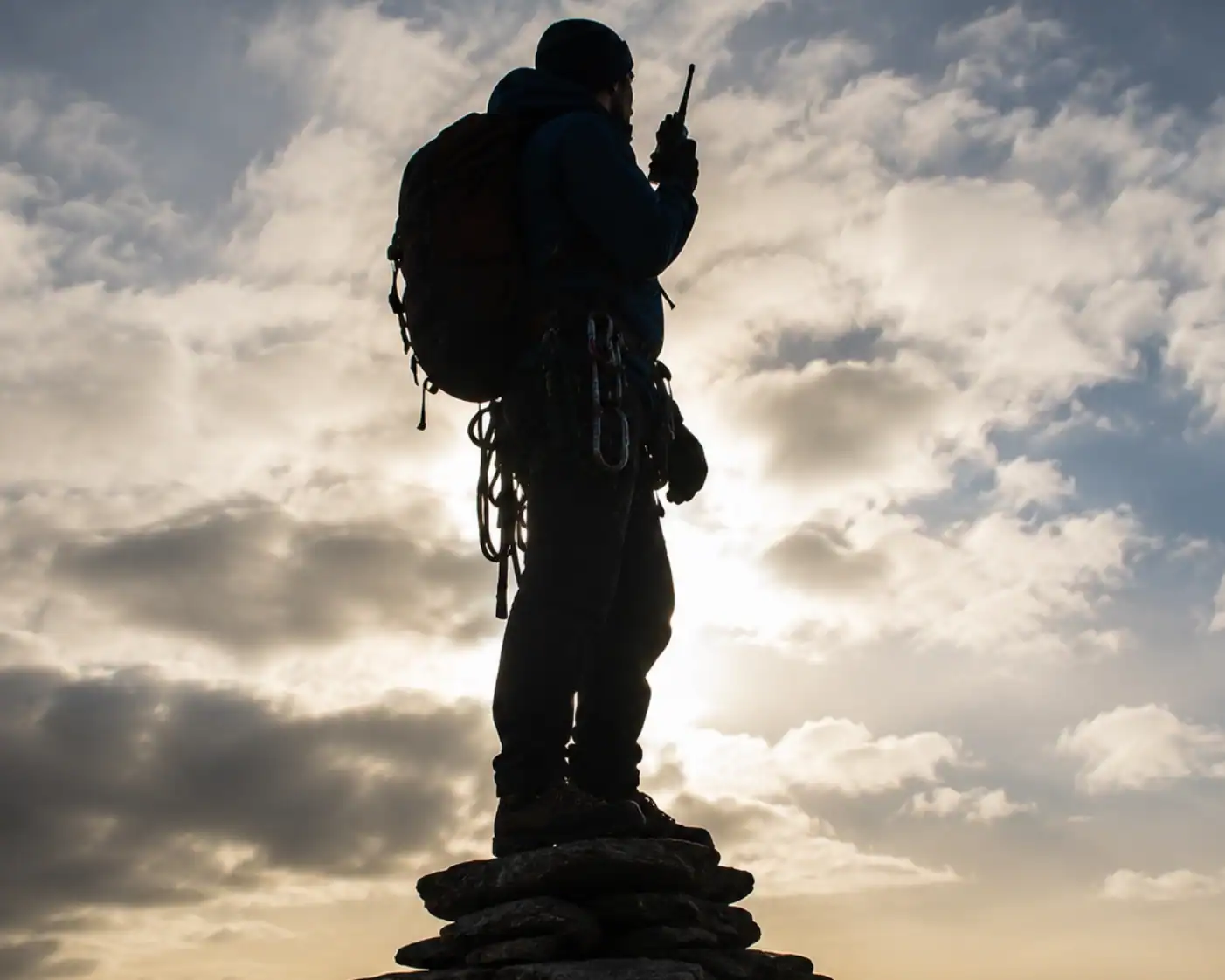 man at top of mountain standing on stones man at top of mountain standing on stones